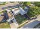 Drone image showcasing the metal roof, driveway, and fenced yard at 5520 Fulmar Dr, Tampa, FL 33625