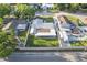 An aerial view of a home with a spacious lawn, screened in porch, and RV parking at 5520 Fulmar Dr, Tampa, FL 33625