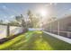 Spacious backyard showcases lush lawn, privacy fencing, and a screened-in lanai at 5520 Fulmar Dr, Tampa, FL 33625