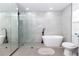 Modern bathroom featuring a glass enclosed shower and soaking tub with black hardware and tile surround at 5520 Fulmar Dr, Tampa, FL 33625