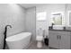 Contemporary bathroom with a soaking tub, modern vanity, and sleek fixtures, all illuminated by a natural light at 5520 Fulmar Dr, Tampa, FL 33625