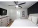 Cozy bedroom featuring a detailed accent wall, comfortable bed, and soft lighting, creating a relaxing atmosphere at 5520 Fulmar Dr, Tampa, FL 33625