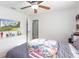 This bright bedroom features a ceiling fan, and a TV on the wall for entertainment, and a cheerful Marvel themed bedspread at 5520 Fulmar Dr, Tampa, FL 33625