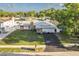 Charming single-story home boasts a metal roof, stone accents, a well-manicured lawn, and a paved driveway at 5520 Fulmar Dr, Tampa, FL 33625
