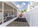 The backyard features a screened-in patio, white fence, and outdoor storage options at 5520 Fulmar Dr, Tampa, FL 33625