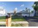 Beautiful single-story house with well-manicured lawn, stone chimney, metal roof, and black mailbox on a wooden post at 5520 Fulmar Dr, Tampa, FL 33625