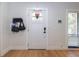 Inviting front door with decorative window, smart lock, and convenient coat rack for stylish organization at 5520 Fulmar Dr, Tampa, FL 33625