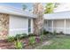 Charming exterior with stone accents, metal roof, and lush landscaping at 5520 Fulmar Dr, Tampa, FL 33625