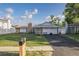 Charming home featuring stone accents, a well-manicured lawn, and a cozy front patio at 5520 Fulmar Dr, Tampa, FL 33625