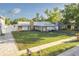 Inviting home with well-maintained lawn, stone details, and a driveway leading to garage at 5520 Fulmar Dr, Tampa, FL 33625