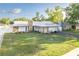 A well-maintained home with a metal roof, stone accents, and lush landscaping at 5520 Fulmar Dr, Tampa, FL 33625