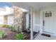 Charming front porch featuring a stone pillar and welcoming decor with well maintained landscaping at 5520 Fulmar Dr, Tampa, FL 33625