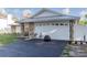 A two-car garage with stylish stone accents and a metal roof at 5520 Fulmar Dr, Tampa, FL 33625