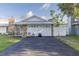 Two car garage featuring decorative stone work at 5520 Fulmar Dr, Tampa, FL 33625