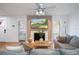 Bright living room featuring a fireplace, wood floors, a ceiling fan, and lots of natural light at 5520 Fulmar Dr, Tampa, FL 33625