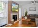 Inviting living room features a fireplace, wood floors, and abundant natural light through the large windows at 5520 Fulmar Dr, Tampa, FL 33625