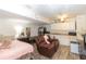 Open living space features a kitchenette, a plush leather recliner, and ample natural light at 5520 Fulmar Dr, Tampa, FL 33625