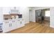 Bright living space with white cabinets, sleek countertops, and a door leading to a sunlit room at 5520 Fulmar Dr, Tampa, FL 33625