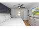Relaxing main bedroom features a ceiling fan, stylish dresser, and neutral colors creating a calming atmosphere at 5520 Fulmar Dr, Tampa, FL 33625