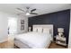 Beautiful bedroom features a black accent wall, a ceiling fan and a doorway to the elegant bathroom at 5520 Fulmar Dr, Tampa, FL 33625