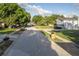A street view of a home with mature trees and a well-maintained lawn at 5520 Fulmar Dr, Tampa, FL 33625