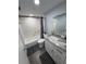 Bright bathroom featuring a shower-tub combination with subway tile and a modern vanity with granite countertop at 5555 Gulf Blvd # 315, St Pete Beach, FL 33706