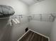 Walk-in closet featuring shelving and wood flooring at 5555 Gulf Blvd # 315, St Pete Beach, FL 33706