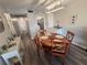 Charming dining area featuring a round wooden table and seating for four with access to the kitchen at 5555 Gulf Blvd # 315, St Pete Beach, FL 33706