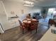 Open-concept dining area with seating for four adjacent to the kitchen and living spaces at 5555 Gulf Blvd # 315, St Pete Beach, FL 33706
