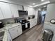 Modern kitchen featuring white cabinets, stainless steel appliances, and granite countertops at 5555 Gulf Blvd # 315, St Pete Beach, FL 33706