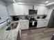 Modern kitchen featuring white cabinets, stainless steel appliances, and granite countertops at 5555 Gulf Blvd # 315, St Pete Beach, FL 33706