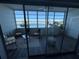 Relaxing lanai featuring comfortable seating with stunning water views from large picture windows at 5555 Gulf Blvd # 315, St Pete Beach, FL 33706