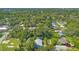 Expansive aerial view of a neighborhood with mature trees and various styles of houses at 5724 Casson Ave, New Port Richey, FL 34652