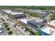 Aerial view highlighting a commercial streetscape lined with businesses and palm trees at 5724 Casson Ave, New Port Richey, FL 34652
