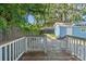 View from the deck shows a blue storage shed and a fenced yard with mature trees at 5724 Casson Ave, New Port Richey, FL 34652