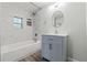 Beautifully renovated bathroom featuring a new vanity, updated tile, and modern fixtures, creating a spa-like feel at 5724 Casson Ave, New Port Richey, FL 34652