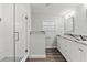 Bright bathroom with glass shower and double granite vanity at 5724 Casson Ave, New Port Richey, FL 34652
