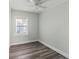 Neutral bedroom features ceiling fan, laminate floors and natural light at 5724 Casson Ave, New Port Richey, FL 34652