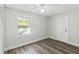 Bright bedroom boasts new laminate floors and lots of natural light at 5724 Casson Ave, New Port Richey, FL 34652