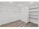 Walk-in closet features laminate floors and shelving system at 5724 Casson Ave, New Port Richey, FL 34652