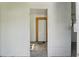 Interior view through a white doorway with a wood frame and white door at the back at 5724 Casson Ave, New Port Richey, FL 34652