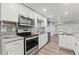 Bright kitchen features stainless steel appliances, granite counters and tiled backsplash at 5724 Casson Ave, New Port Richey, FL 34652