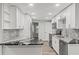 Modern kitchen featuring granite countertops, stainless steel appliances, and sleek white cabinetry for a contemporary look at 5724 Casson Ave, New Port Richey, FL 34652