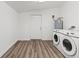 This laundry room features a washer and dryer and a doorway to the exterior at 5724 Casson Ave, New Port Richey, FL 34652