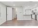 Inviting open-concept living area with modern flooring, leading to a stylish kitchen and contemporary bathroom at 5724 Casson Ave, New Port Richey, FL 34652