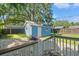 Exterior view of the blue storage shed with a white door in the backyard at 5724 Casson Ave, New Port Richey, FL 34652