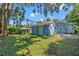 Blue shed in a backyard with mossy grass and tree limbs overhead at 5724 Casson Ave, New Port Richey, FL 34652