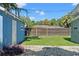 Backyard showing the blue storage shed, fence, and partial grass with gravel at 5724 Casson Ave, New Port Richey, FL 34652