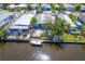 Waterfront property with boat, canal access, and views of neighboring homes in a tranquil community setting at 5824 Portsmouth Dr, Tampa, FL 33615