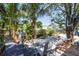 Lush backyard with tropical plants, mature trees, and outdoor seating area, perfect for relaxation at 5824 Portsmouth Dr, Tampa, FL 33615